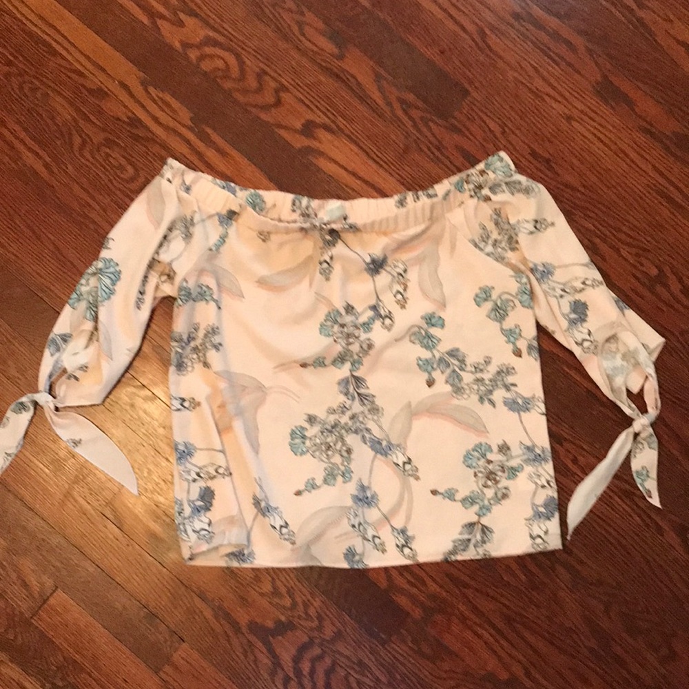 Such a pretty off shoulder blouse. Cute ties on arms perfect for day or evening.